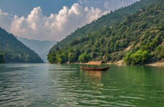 Traditional wooden boat floating on a serene green lake surrounded by forested hills under a partly cloudy sky