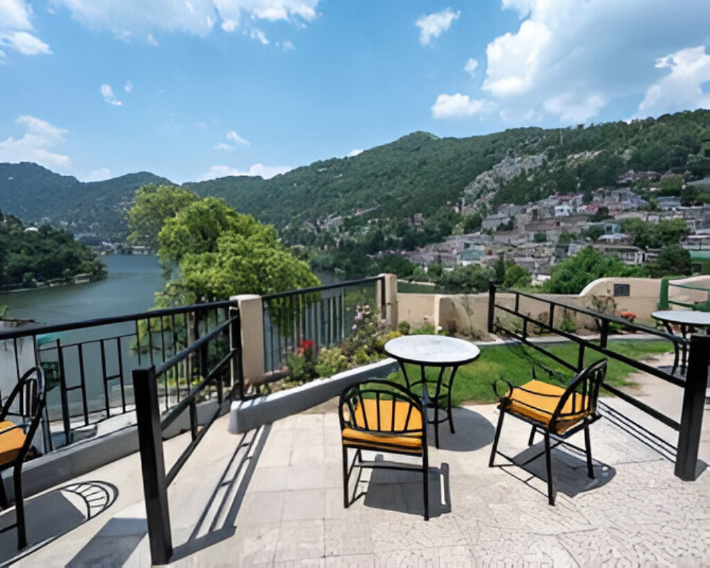 Terrace seating with lake and mountain view at Hotel Himalaya, Nainital"